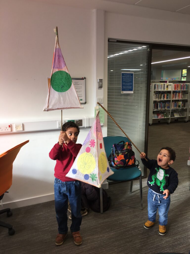 Children holding their completed lanterns at the Weird Sticks Exeter Carnival Lantern Workshop at Exeter Library