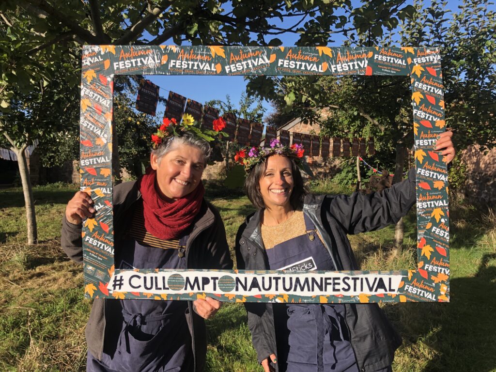 Vik and Hannah from Weird Sticks wearing willow harvest crowns at the Cullompton Autumn Festival