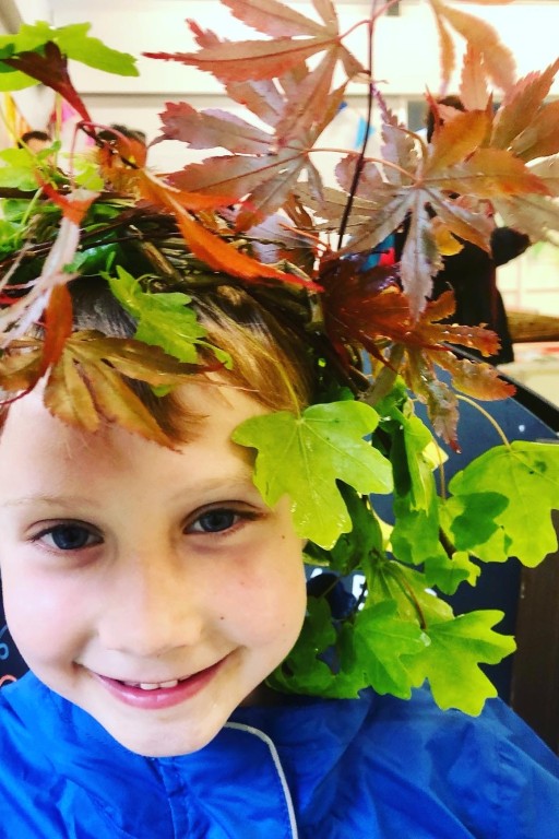 Child wearing his willow crown created at the Weird Sticks workshop during the Play Torbay Coronation Breakfast