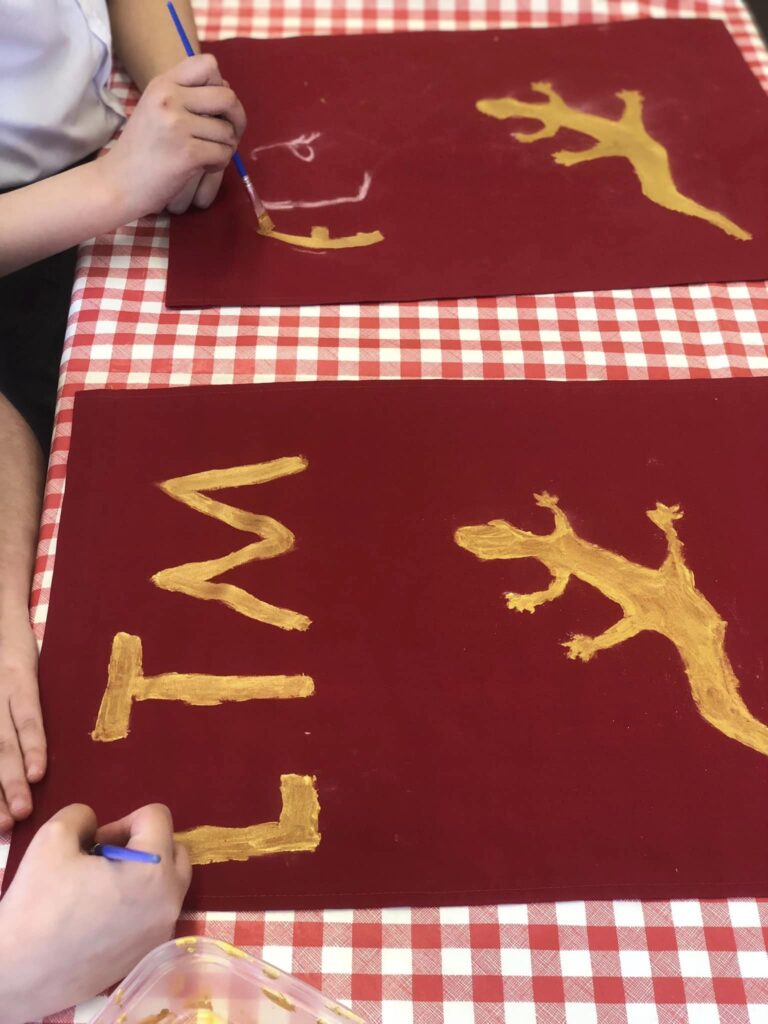 Pupils at Willowbank Primary School decorating their Roman Standard flags during the Weird Sticks workshop