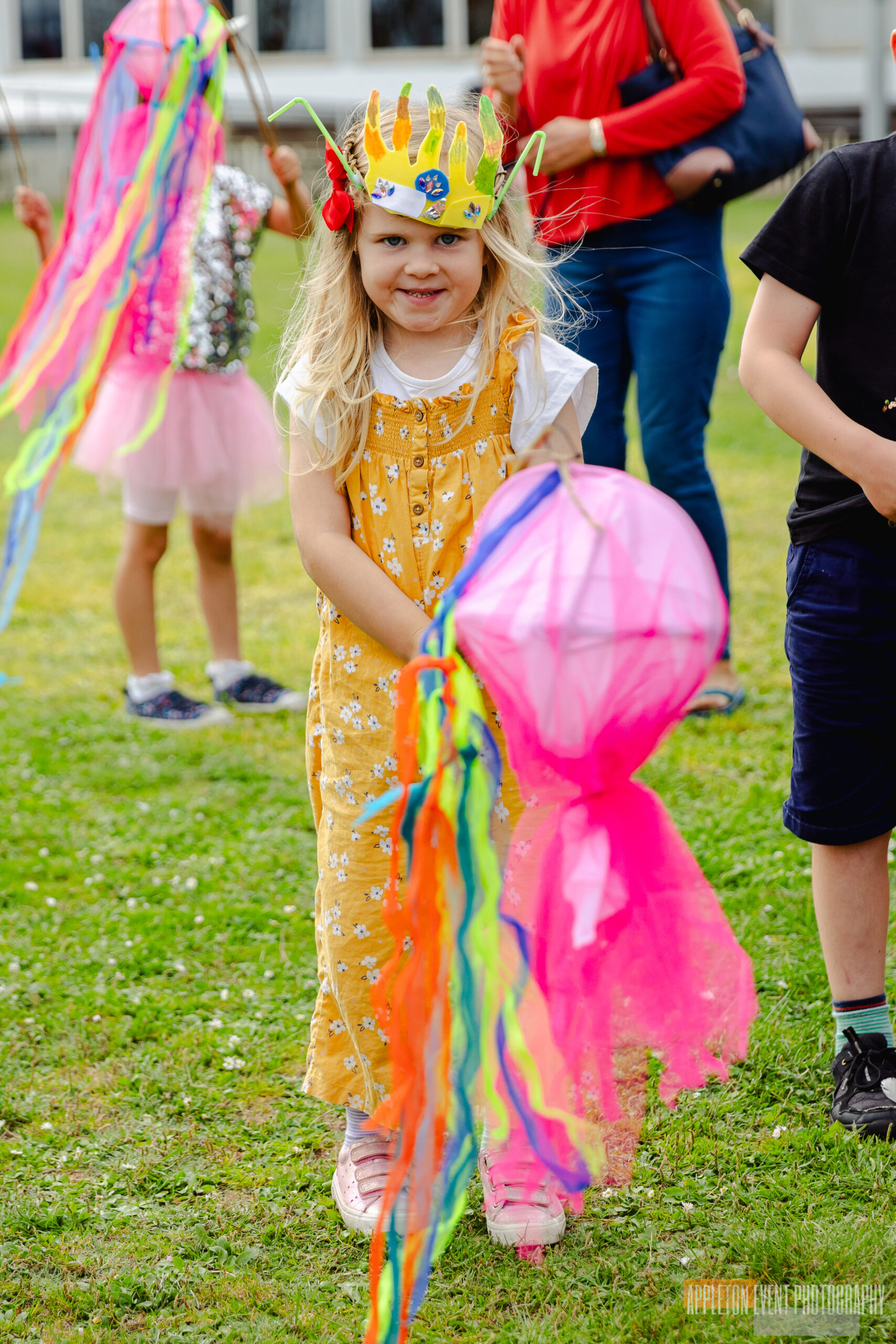 Child posing with her sea creature costume and creations during the Exmouth Festival samba parade