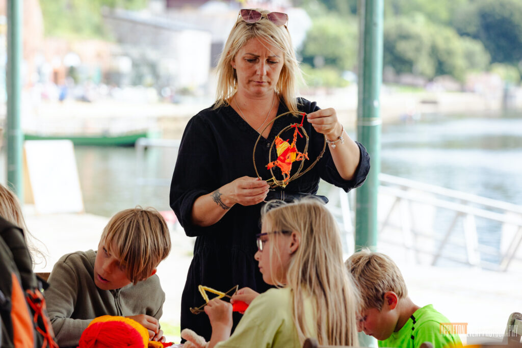 Participants weaving their willow spinning suns at the Weird Sticks workshop, Exeter Quay