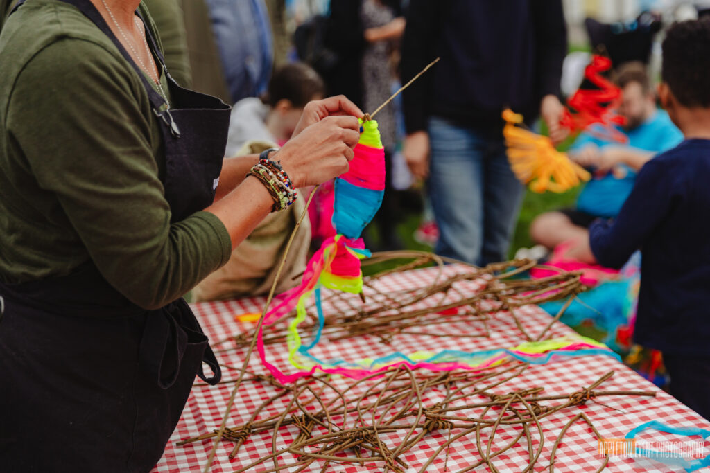 Participants weaving bouncing fish at the weird Sticks workshops during Goodrington Seafest