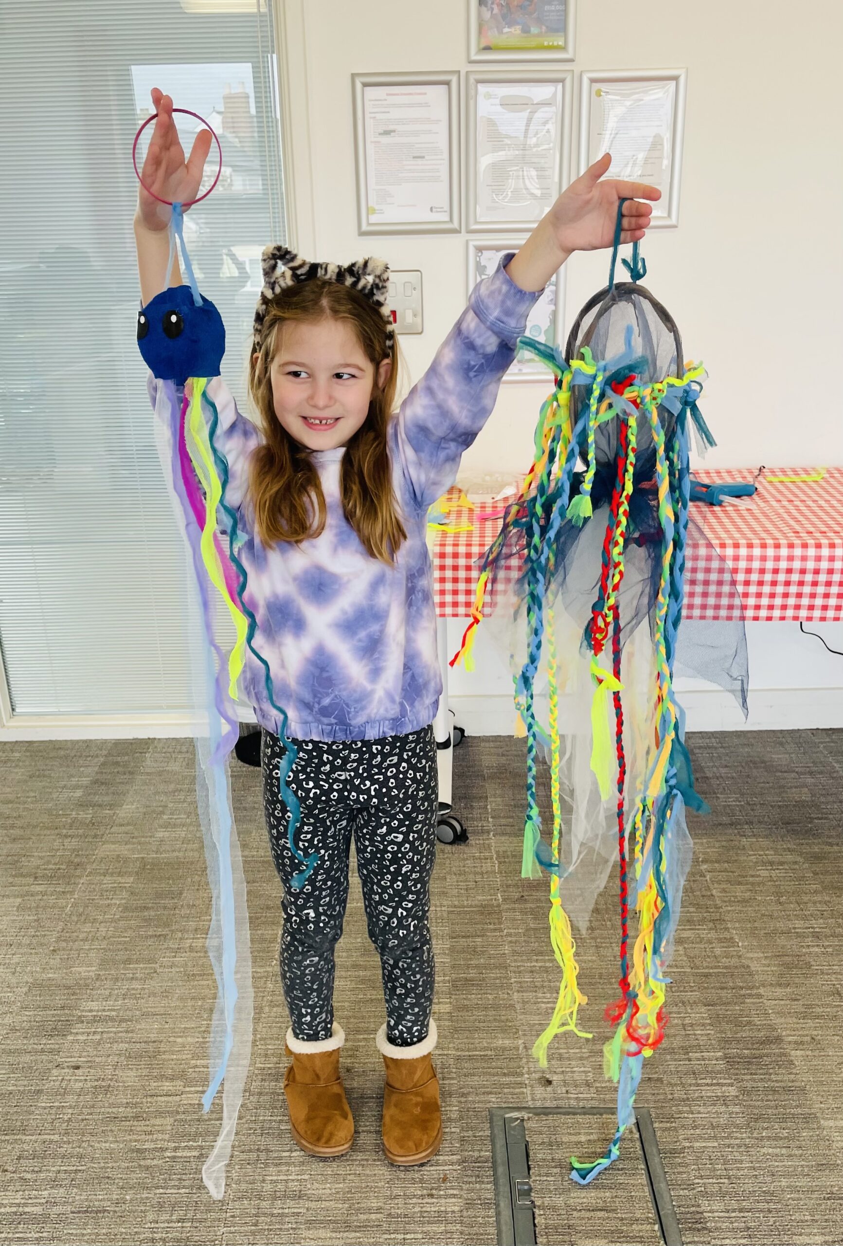 Child displaying their sea creature creations made with Weird Sticks in Cullompton