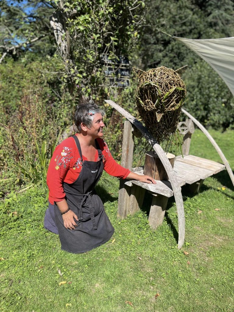 Vik from Weird Sticks with 'Ollie the Owl' sculpture created with Orchard Forest School