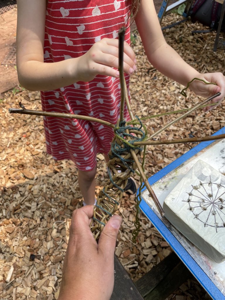 Weird Sticks working with child at Play Torbay to create the Geopark Gateway