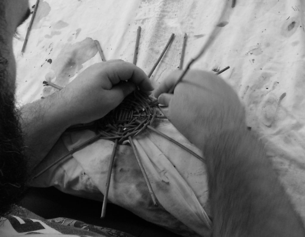 Willow baskets being woven by a participant at HMP Channings Wood during a Weird Sticks workshop as part of the Open Door Project