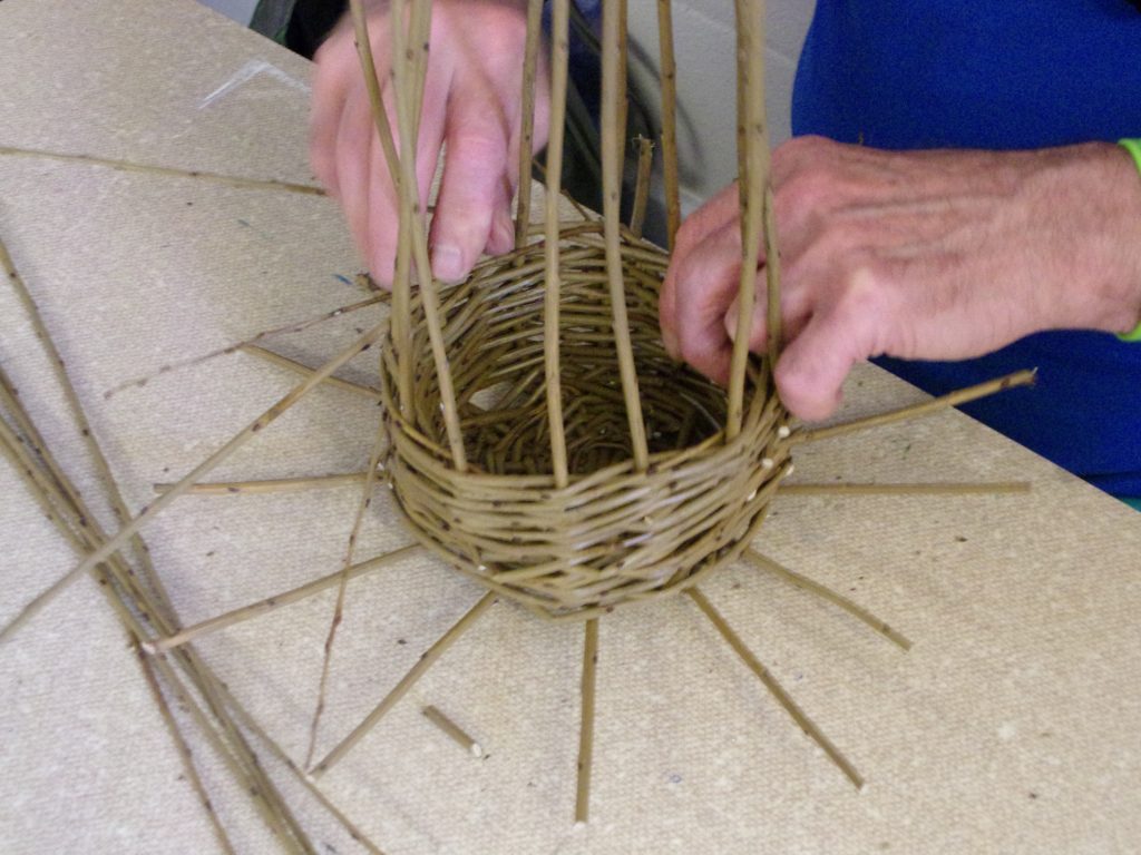 Willow baskets being woven by a participant at HMP Channings Wood during a Weird Sticks workshop as part of the Open Door Project