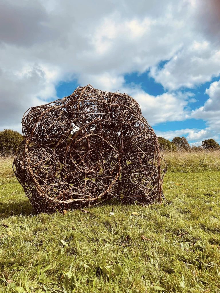 Community created willow Ammonite sculpture with Weird Sticks at A La Ronde